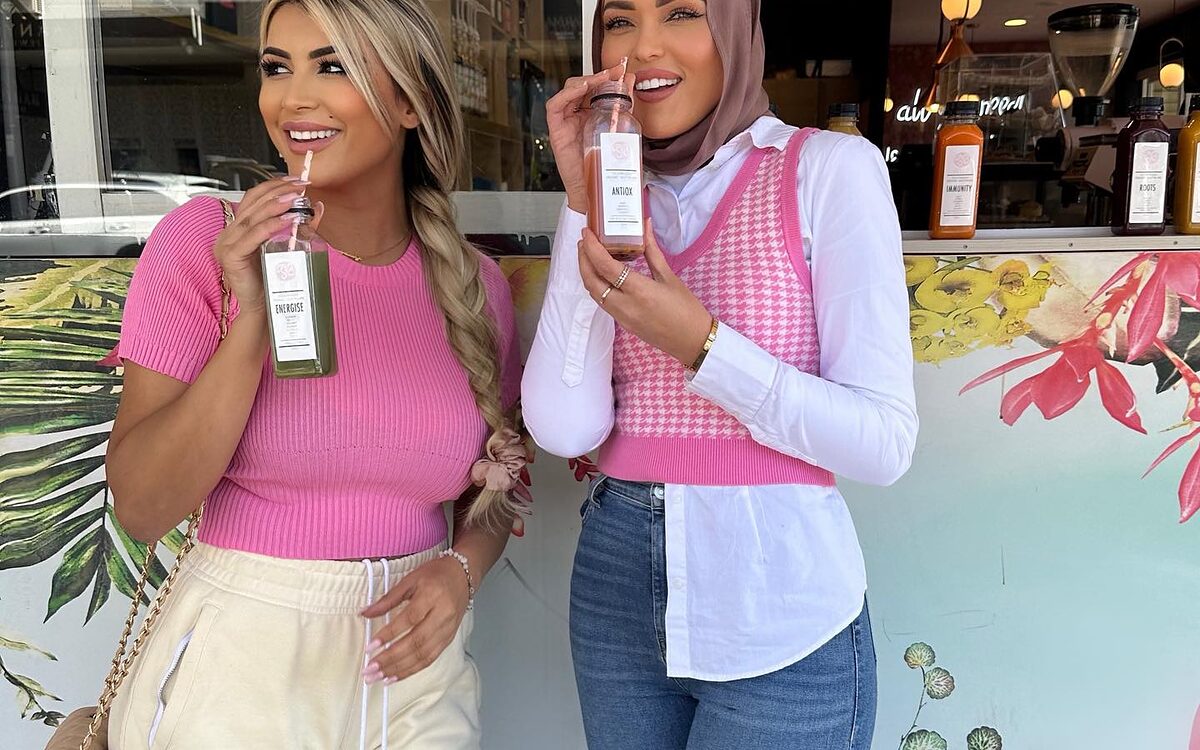 Two customers with Soft Sip drinks outside the cafe on Waterloo Road